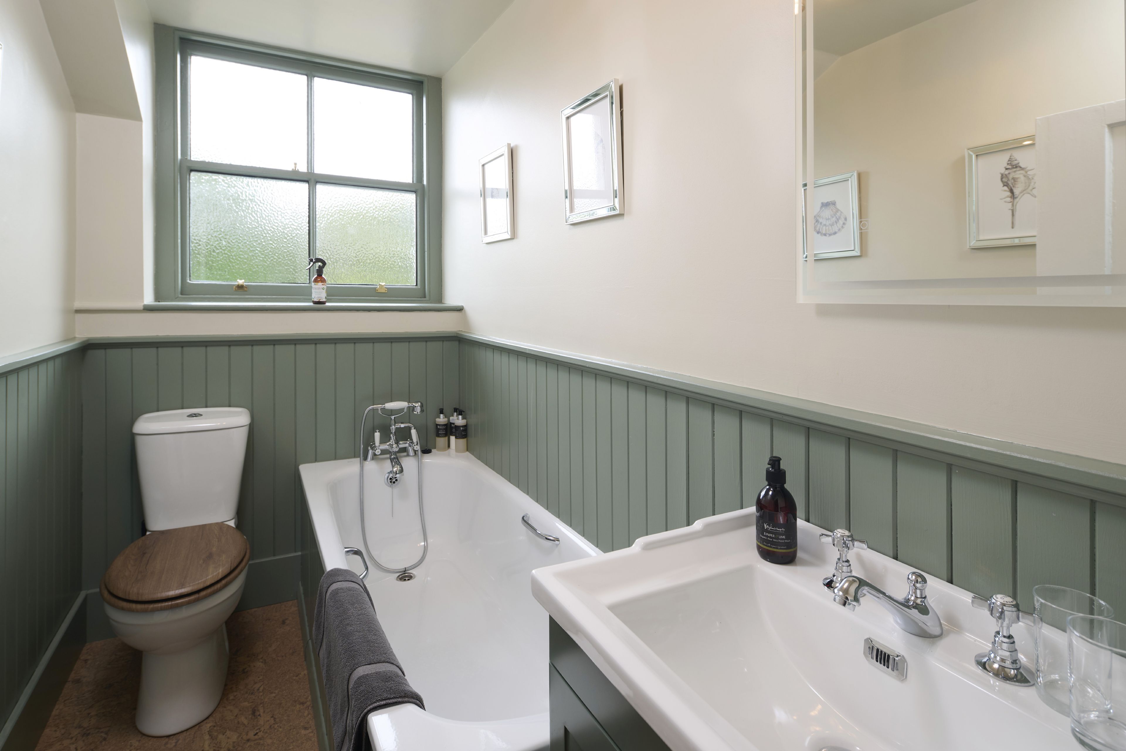A bathroom with a toilet, bathtub, and sink.