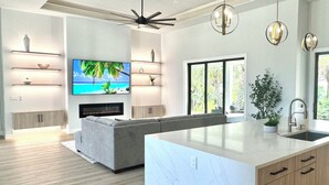 A modern kitchen with a large island, built-in appliances, and a view of the outdoors. - Hidden Gem with Jacuzzi, Waterfront   (North Port)