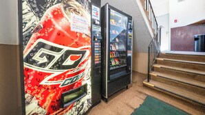 A vending machine with a Coca-Cola logo and a sports-themed mural. - Unicorn Inn by OYO Portland (Portland)