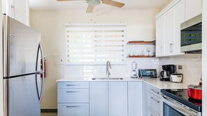 A modern kitchen with a stainless steel refrigerator, a built-in oven, a coffee maker, and a toaster. - Ocean View 2Br/2Bth Condo In Tamarindo (Tamarindo)