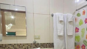 A bathroom with a sink, mirror, toilet, and shower curtain. - Apartamentos Yusem #3

 (Alajuela)