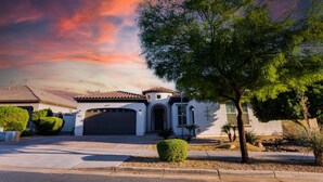 A two-story house with a garage, a driveway, and a well-maintained lawn. - Creekside Queen Creek (Queen Creek)