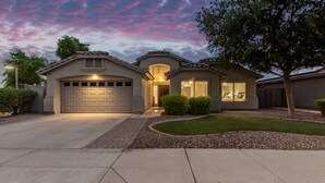 A two-story house with a garage, a covered entryway, and a landscaped front yard. - 165th Goodyear (Goodyear)