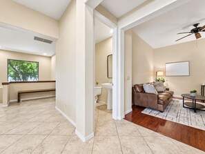 A spacious living area with a brown leather sofa, a coffee table, and a view of the outdoors. - Lynx Chandler/ocotillo (Chandler)