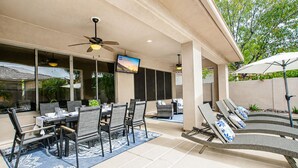 An outdoor patio with a dining table, chairs, and lounge chairs. - Lynx Chandler/ocotillo (Chandler)