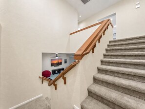 A carpeted staircase with wooden handrails leading to a landing. - Lynx Chandler/ocotillo (Chandler)
