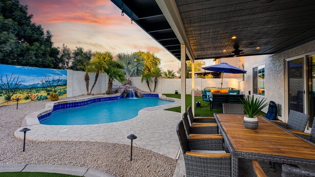 A backyard with a swimming pool, outdoor furniture, and a patio area. - Ocotillo Glendale (Glendale)