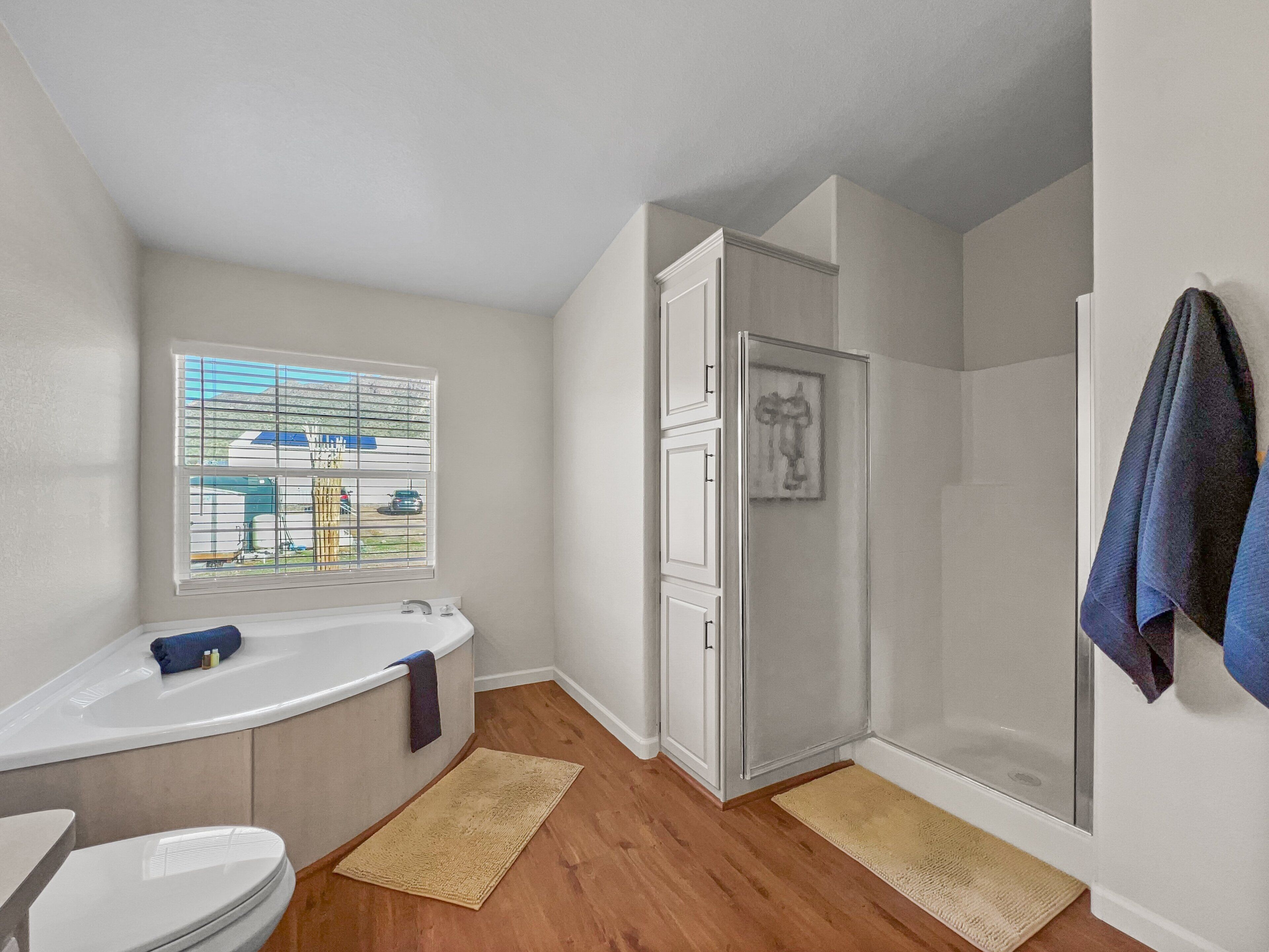 A bathroom with a bathtub, toilet, and shower.