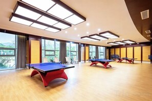 A room with ping pong tables, large windows, and a curved ceiling. - Wei Select Xueye Hotel (Jinan)