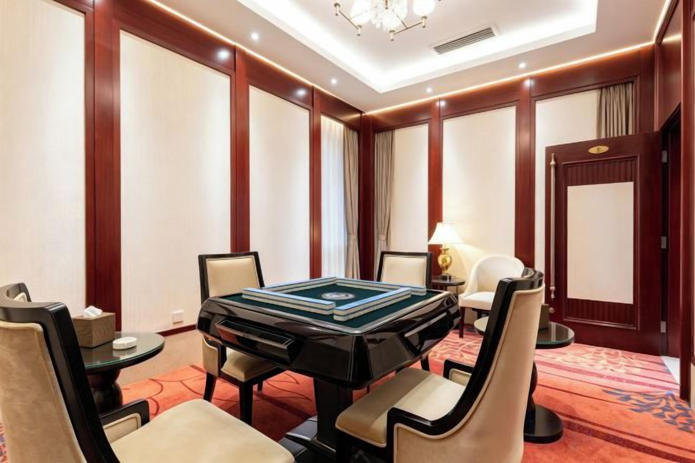 A conference room with a large table, chairs, a lamp, and a door.