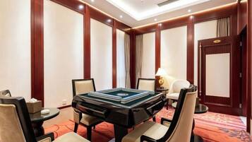 A conference room with a large table, chairs, a lamp, and a door.