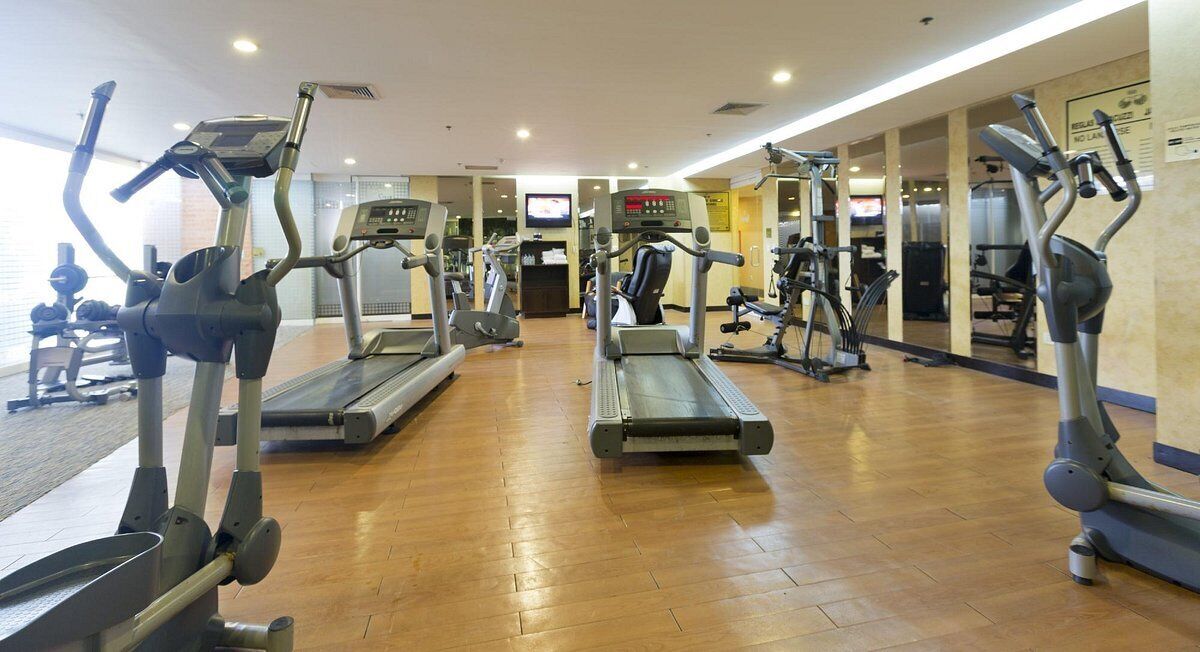 A gym with treadmills, ellipticals, and weight machines.