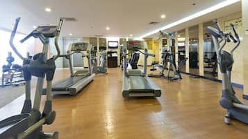A gym with treadmills, ellipticals, and weight machines.