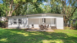 A small, single-story house with a covered patio area. - Classy 4BR Family Home Near FSU (Tallahassee)