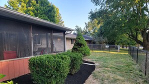 A residential property with a screened porch, a brick exterior, and a landscaped garden with trimmed bushes and a mulched area. - Cute, pet-friendly home in quiet neighborhood. Close to state parks & downtown. (Rockville)