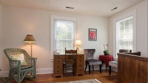 A room with a wooden desk, two chairs, a rocking chair, and a lamp. - Your Centrally Located C-Ville Home Away From Home Vacation Rental  (Charlottesville)