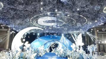 A room with a circular ceiling design, a central light fixture, and a blue carpeted area.