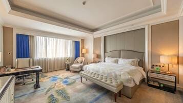 A hotel room with a large bed, a desk, a chair, and a nightstand with lamps.