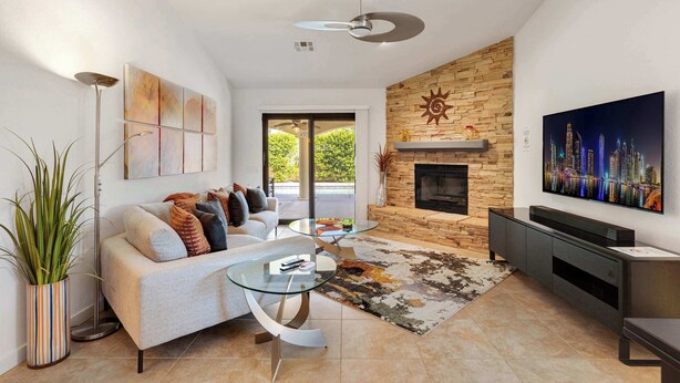 A modern living room with a sofa, coffee table, and fireplace. - Ranch Club Estates Retreat with Pool and Dog Run (Palm Springs)