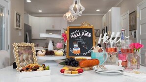 A kitchen with a chalkboard sign, a framed picture, and various food items on the counter. - Royal Estate Maison Entiere de Luxe (Abilene)