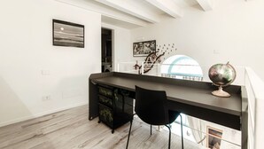 A spacious room with a desk, chair, and a globe on the desk. - Diaz 8 - MyHomeinComo (Como)