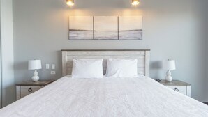 A neatly made bed with white linens, two bedside tables with lamps, and a wall-mounted artwork above the bed. - Las Palomas Phase II Cabrillo 1506 Exceptional Oceanview 2BR 2BA Unit (Puerto Peñasco)