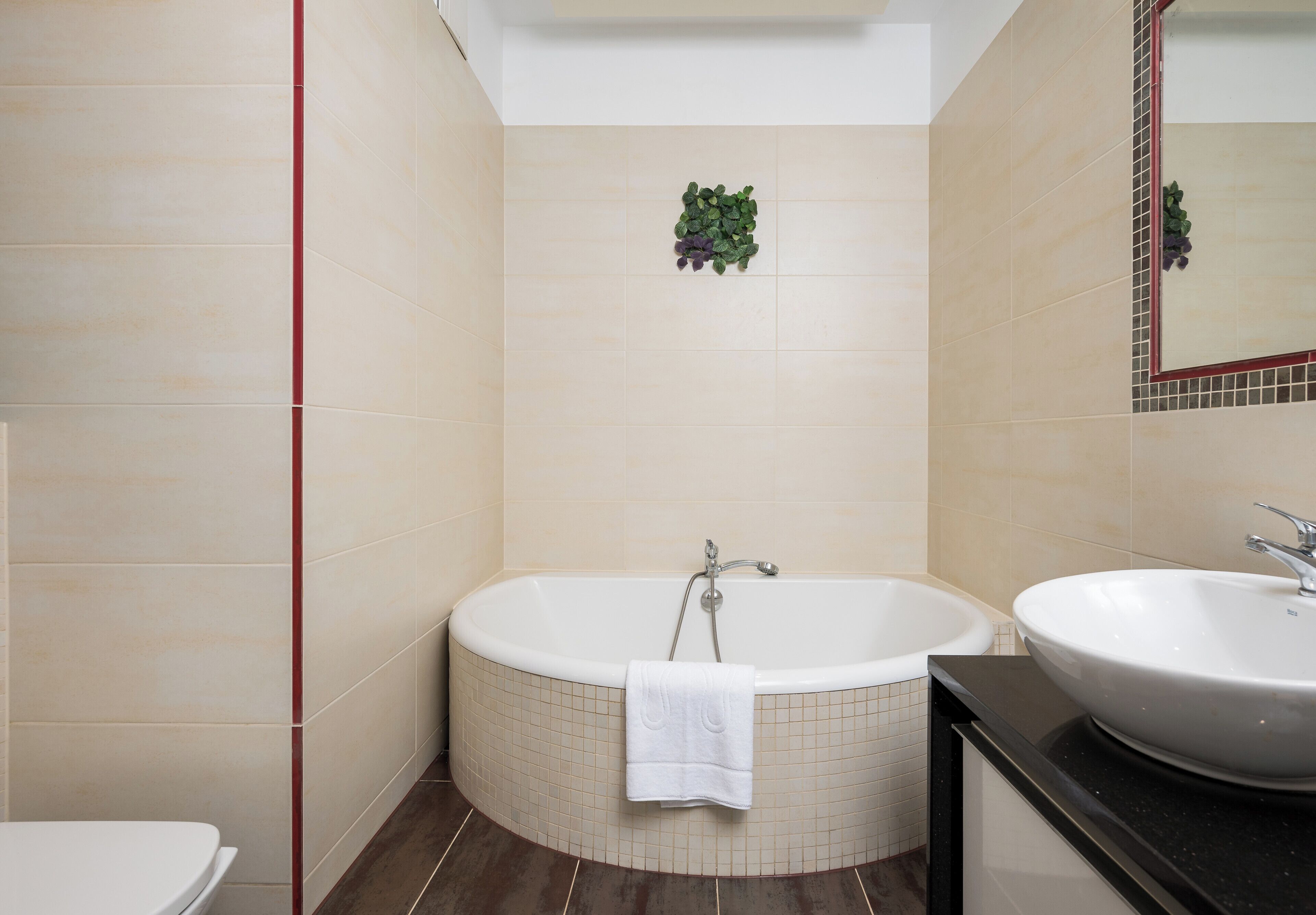 A modern bathroom with a freestanding bathtub, a sink, and a toilet.