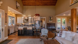 A spacious kitchen with a central island, wooden ceiling, and pendant lighting. - Robin Hoods Retreat - Luxury home, walk to river, hot tub, fire pit! (Jefferson)