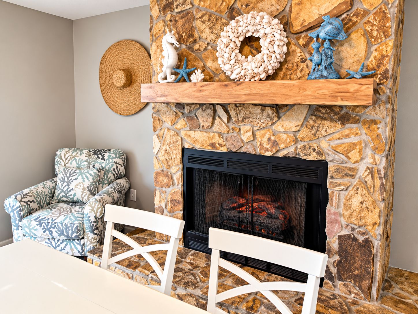 A stone fireplace with a mantel shelf, a woven basket, and decorative items.