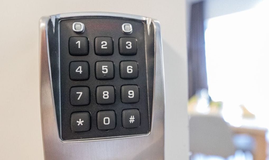 Ein Detailaufnahme einer Zahlentastatur auf einem metallischen Gerät, vermutlich einer Bedienungsplatte im Hotelzimmer.
