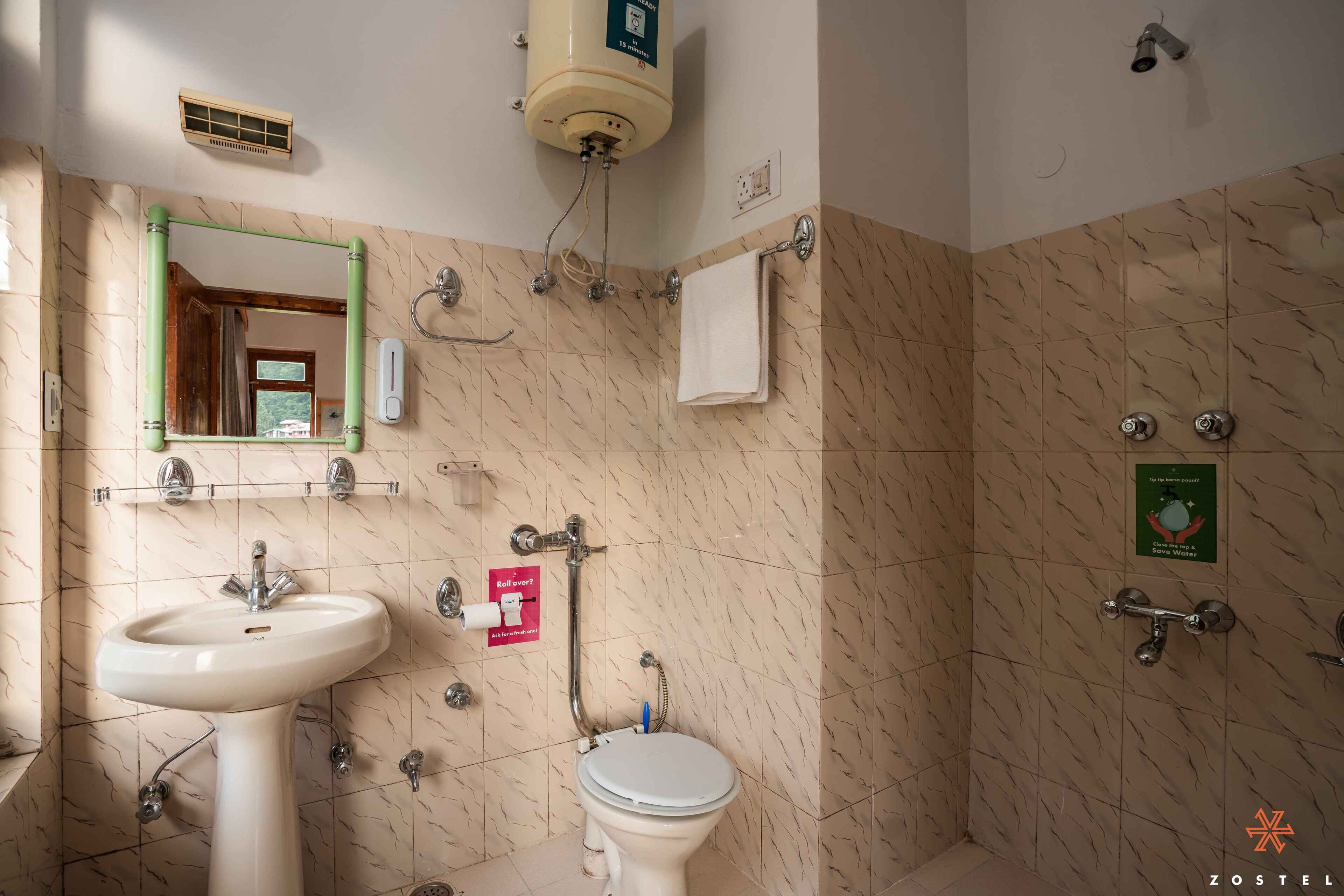A bathroom with a sink, toilet, and shower.