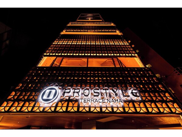 A building with a prominent sign reading 'PROSTYLG TERRACE NAHA' and a patterned facade.