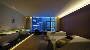 A modern hotel room with a large window, a bathtub, a sofa, and a bed. - YTL ChangChengYunYue Hotel (Wenzhou)