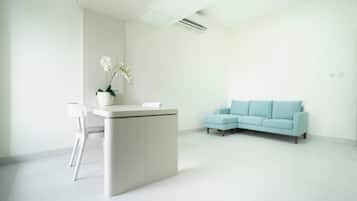 Standard Suite, Balcony | Living room | 24-inch flat-screen TV with cable channels