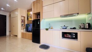 A modern kitchen with a built-in refrigerator, a microwave, and a coffee maker.