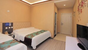 A hotel room with two beds, a desk with a TV, and a door leading to another room. - Tanya Hotel (Changchun Guoshang Department Store Tiandi 12th Fang) (Changchun)