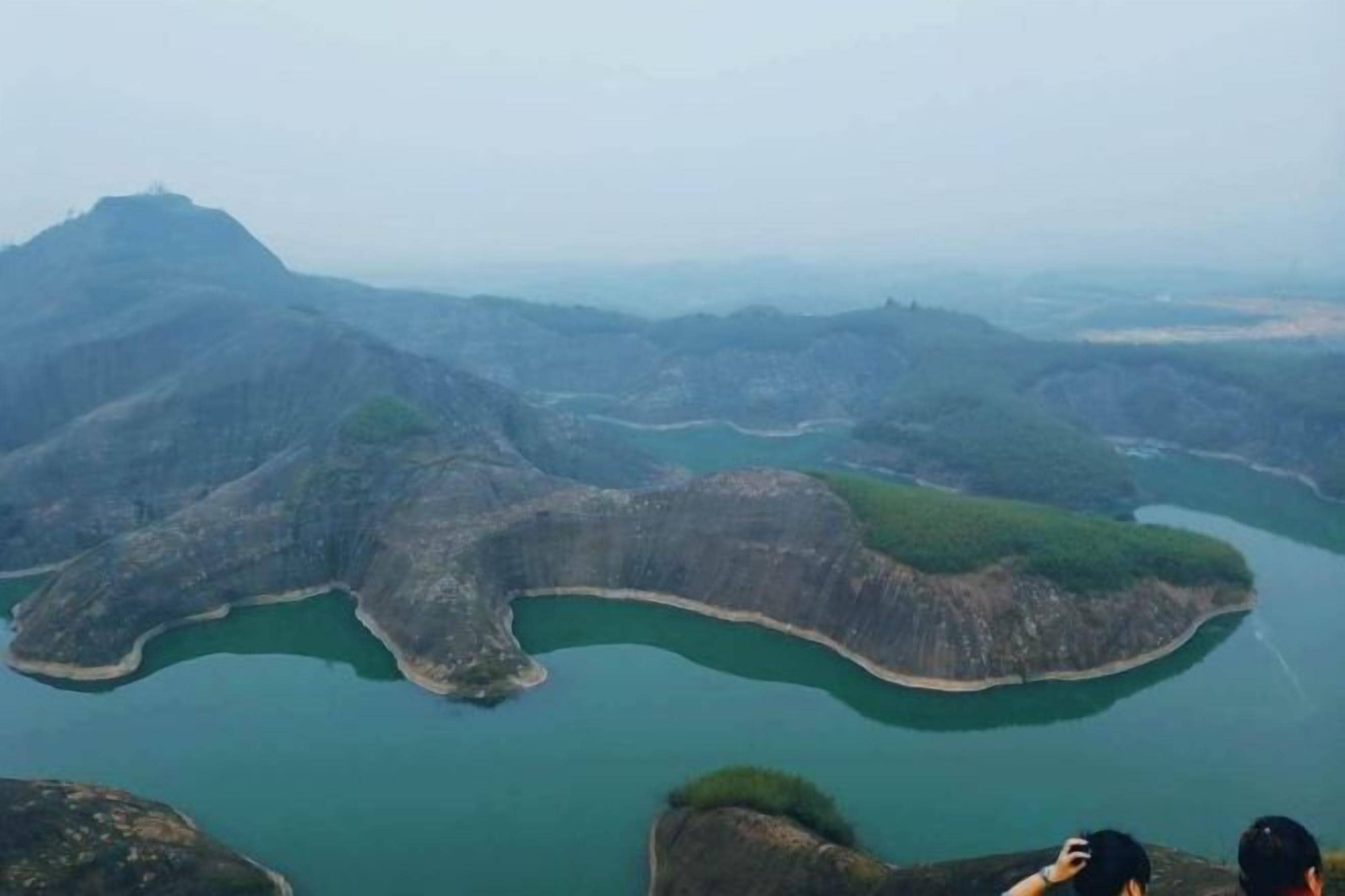 A panoramic view of a mountainous landscape with a river meandering through the terrain.