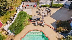 An aerial view of a backyard with a swimming pool, outdoor seating, and a barbecue area. - Spacious 5-bedroom farmhouse in peaceful Nokesville with Pool (Nokesville)