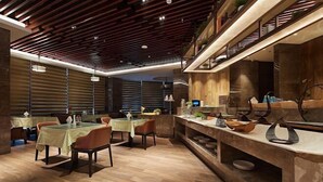 A modern dining area with wooden flooring, tables with checkered tablecloths, and a counter with kitchenware. - Yue Hotel (Fuzhou)