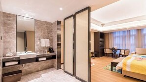 A modern hotel room with a large mirror, a sink, a bed, a desk, and a chair. - Yue Hotel (Fuzhou)