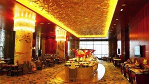 A spacious hotel lobby with a central round table, ornate ceiling, and patterned carpet. - Ningwozhuang Hotel (Building 1) (Lanzhou)