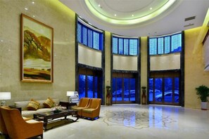 A lobby with a large painting, seating area, and large windows. - Ningwozhuang Hotel (Building 1) (Lanzhou)