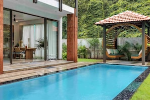 A modern house with a swimming pool, a patio with outdoor furniture, and a covered area with a staircase. - Casa Maxima - 4BR w Private Pool 1km to the Beach (Nerul)