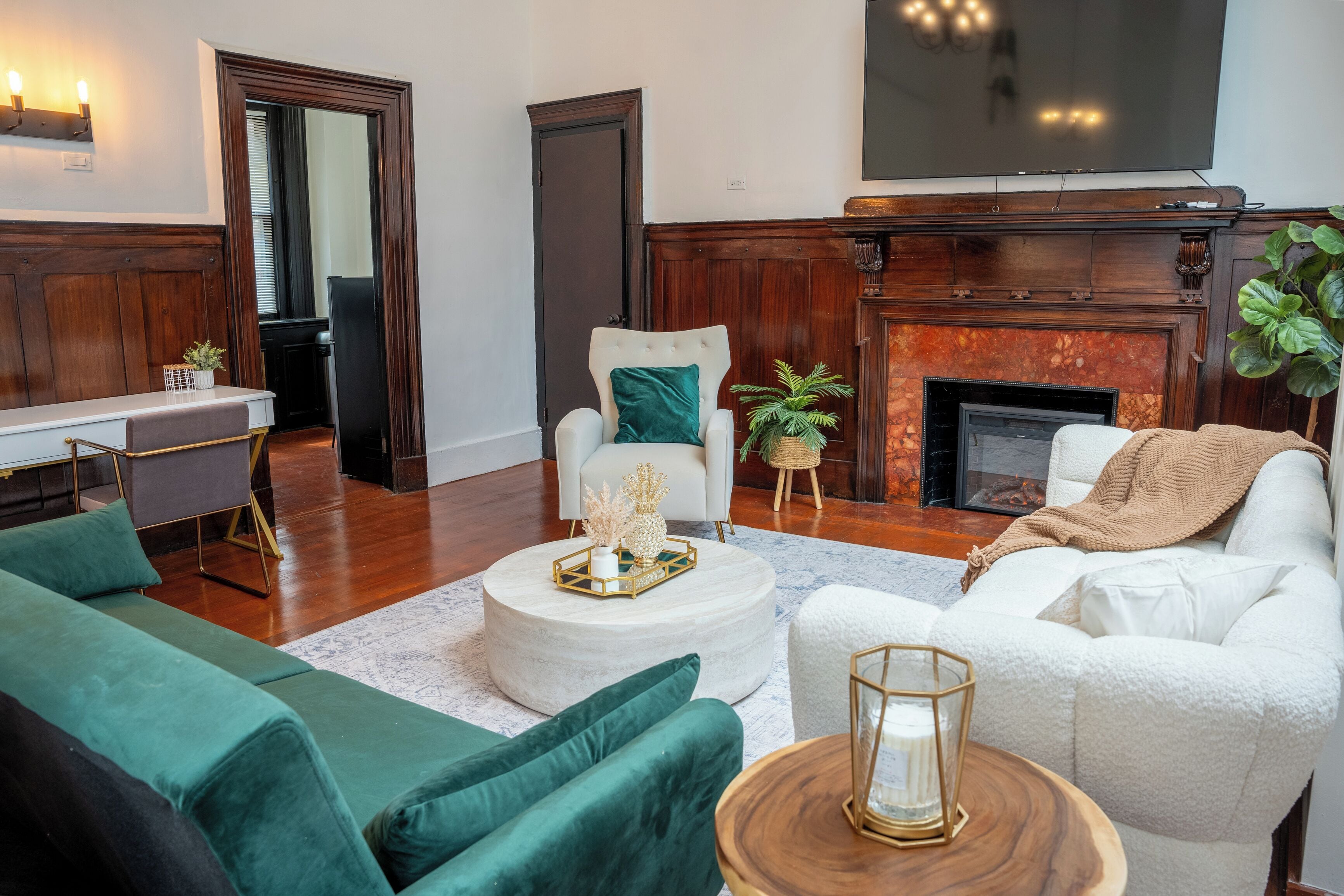 A living room with a fireplace, a sofa, a chair, and a coffee table.
