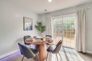 A dining area with a round table, chairs, and a potted plant. - Louisville Home w/ Large Yard: 15 Mi to Downtown! (Louisville)