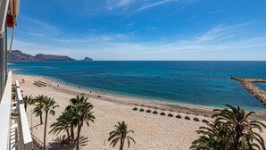 A beach with clear blue water, palm trees, and a rocky breakwater. - Altea Bahia - Altea, Costa Blanca (Altea)