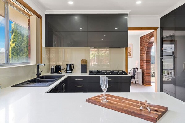 Enjoy cooking in this well-lit kitchen with a large island and gas stove.