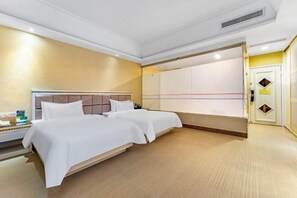 A hotel room with two beds, a wardrobe, and a bedside table. - Yuheng Hotel Foshan (Foshan)