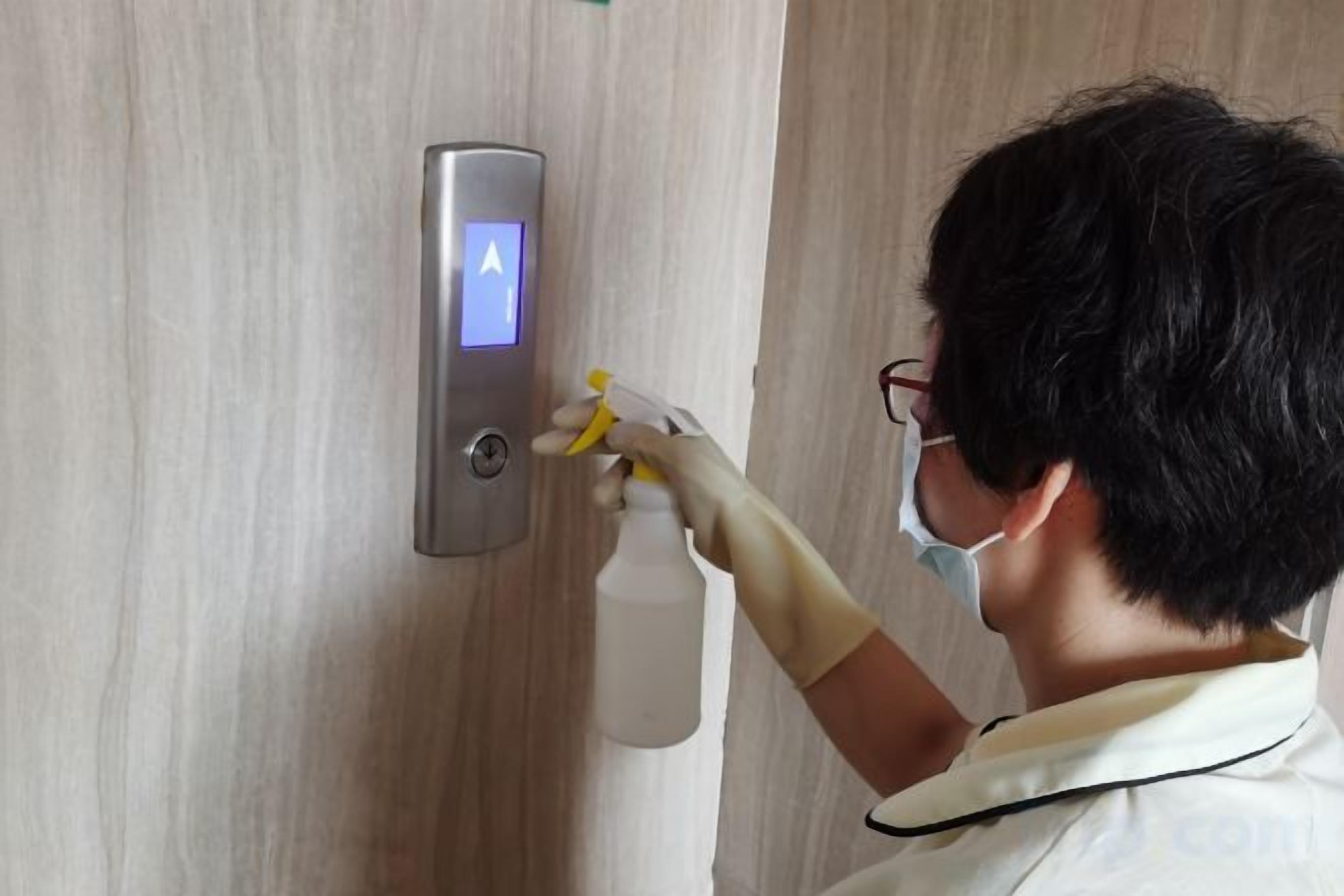 A person using a digital lock on a door with a keypad.