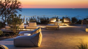 A sunset view from a beachside lounge with outdoor seating and a view of the sea. - Tower of the 7 friars - Tower in Cefalu with direct access to the beach (Cefalù)